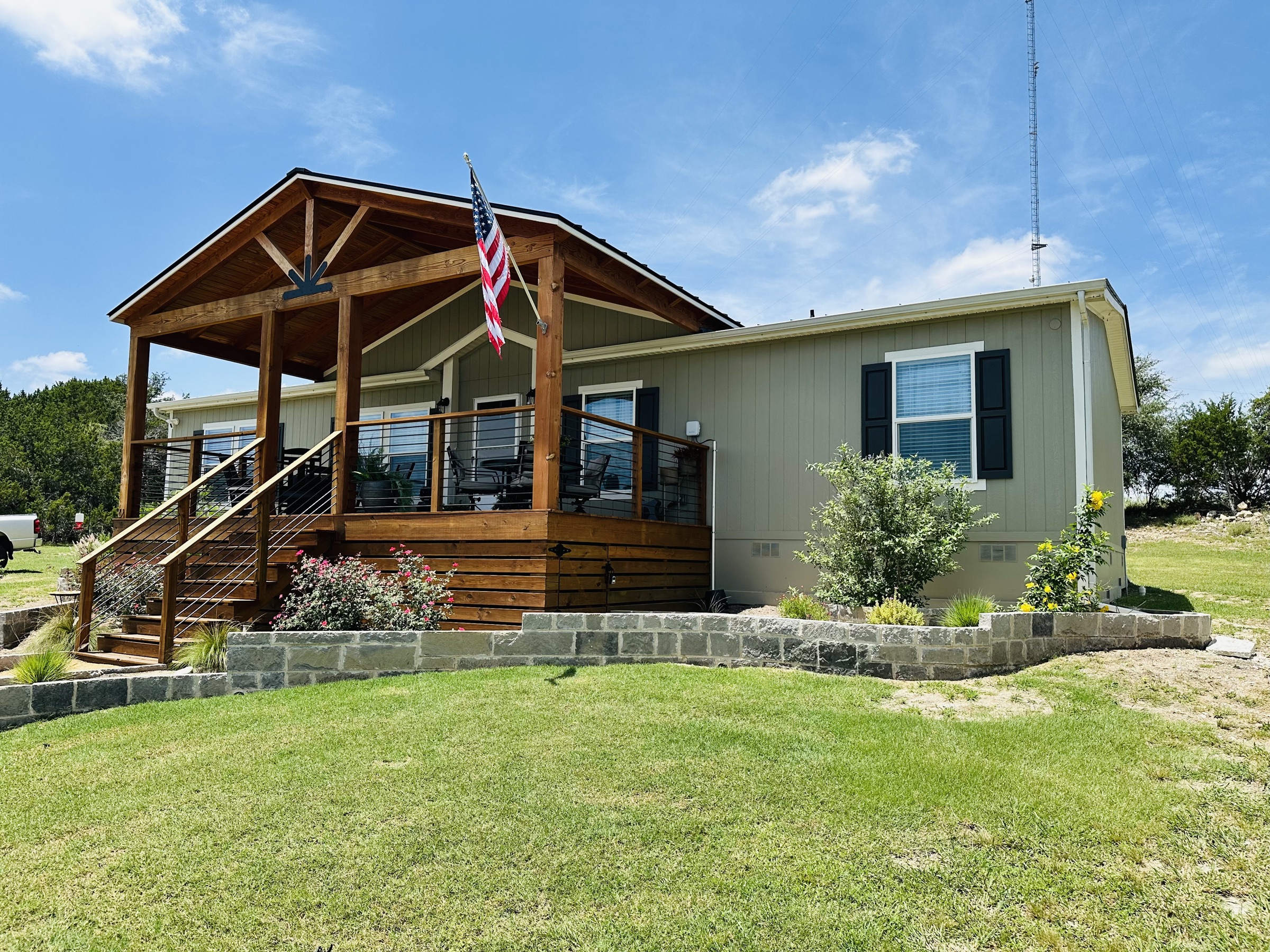 Side view of the house with covered porch and landscaping
