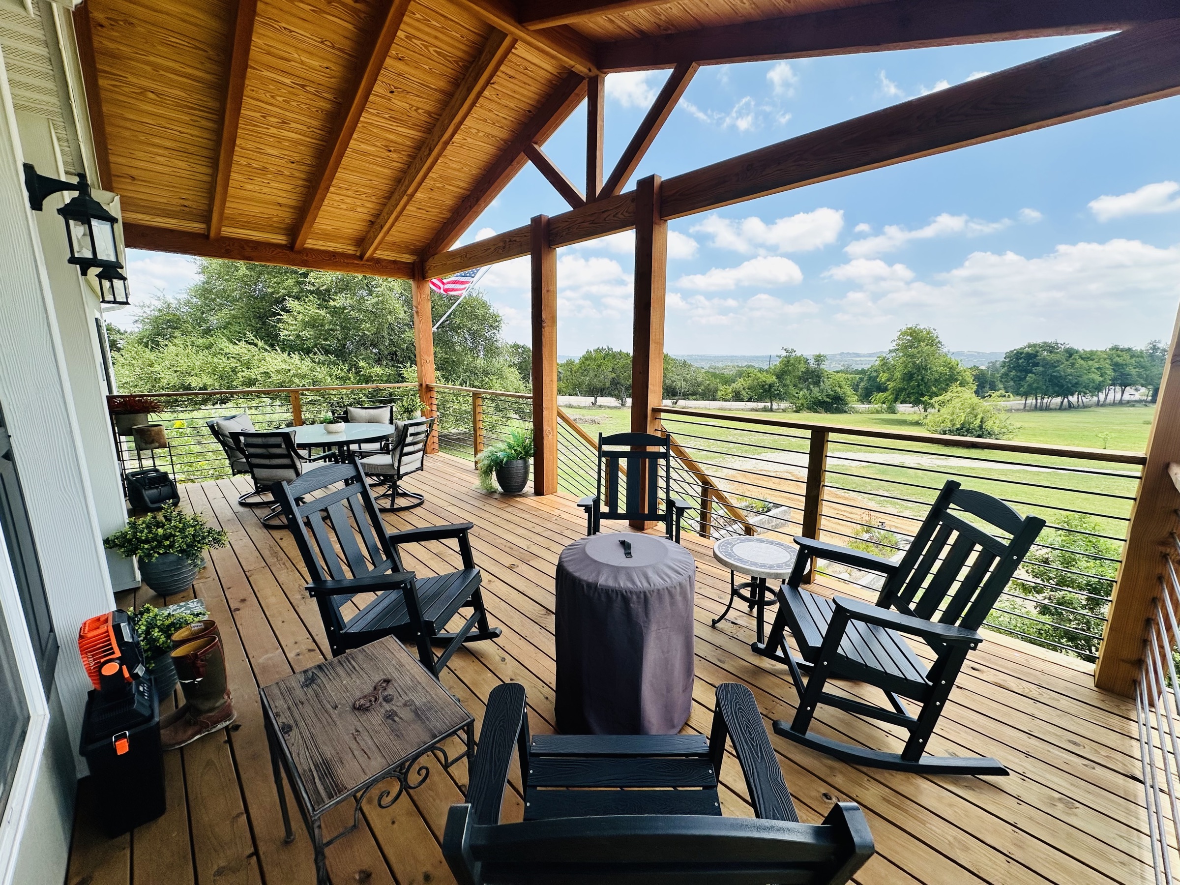 Covered porch with rocking chairs overlooking the Hill Country