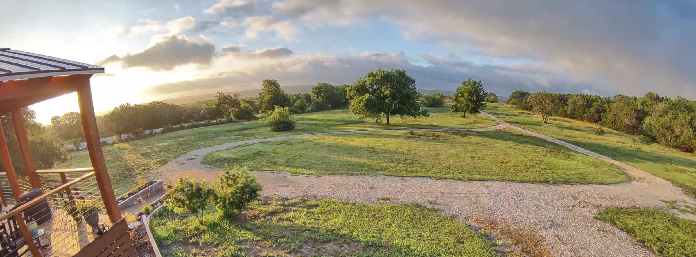 Sunrise over the front yard and gravel drive at Cheval