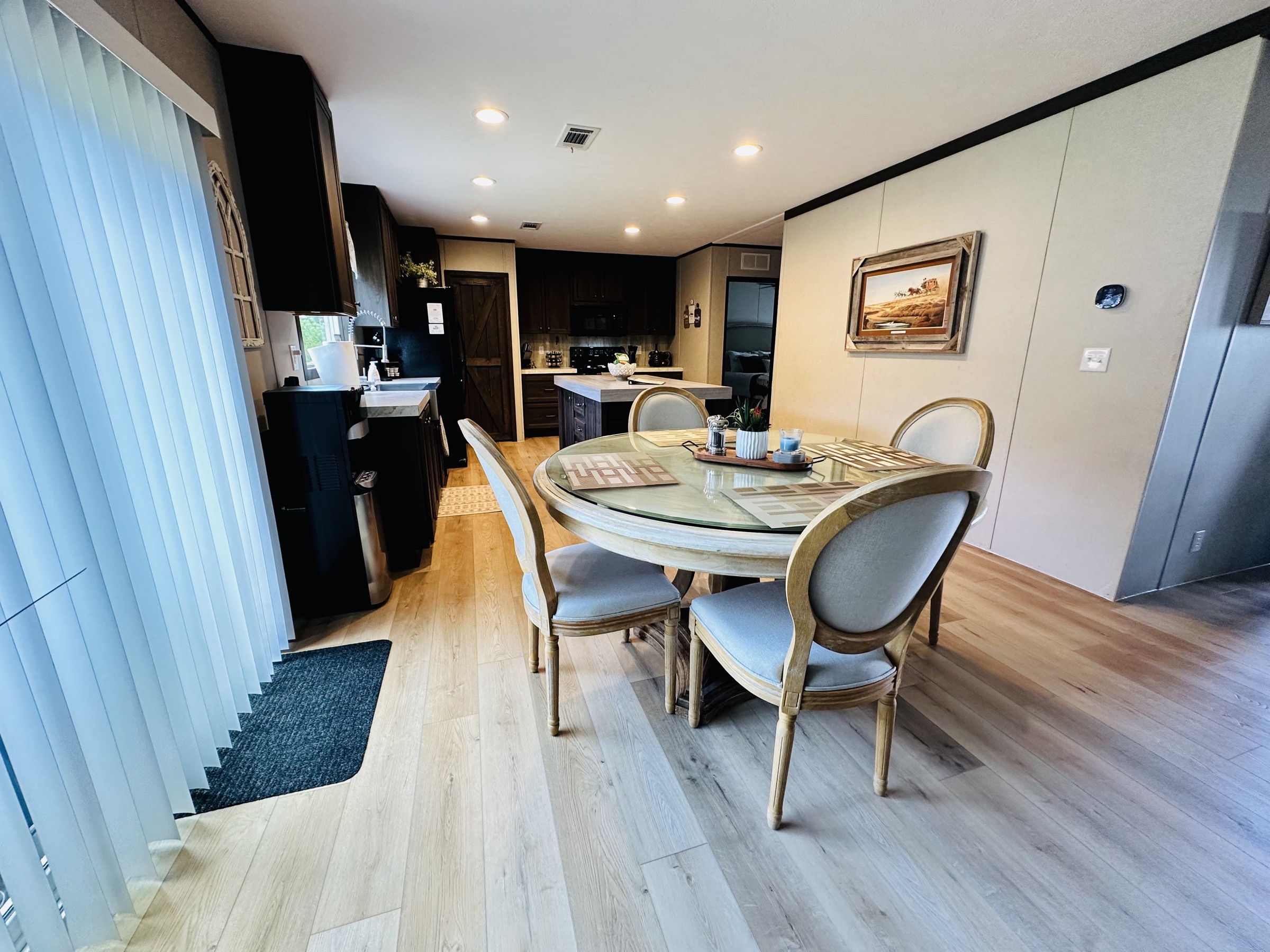 Dining table with kitchen and island in the background
