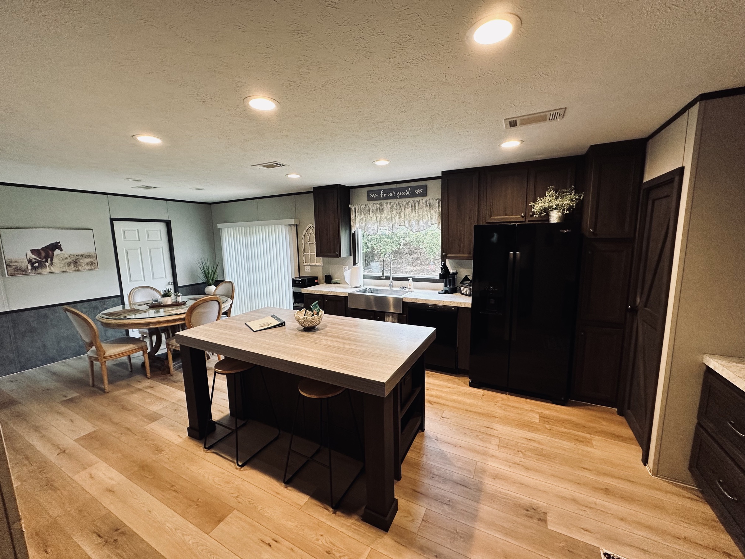 Kitchen with center island, bar seating, and open dining area