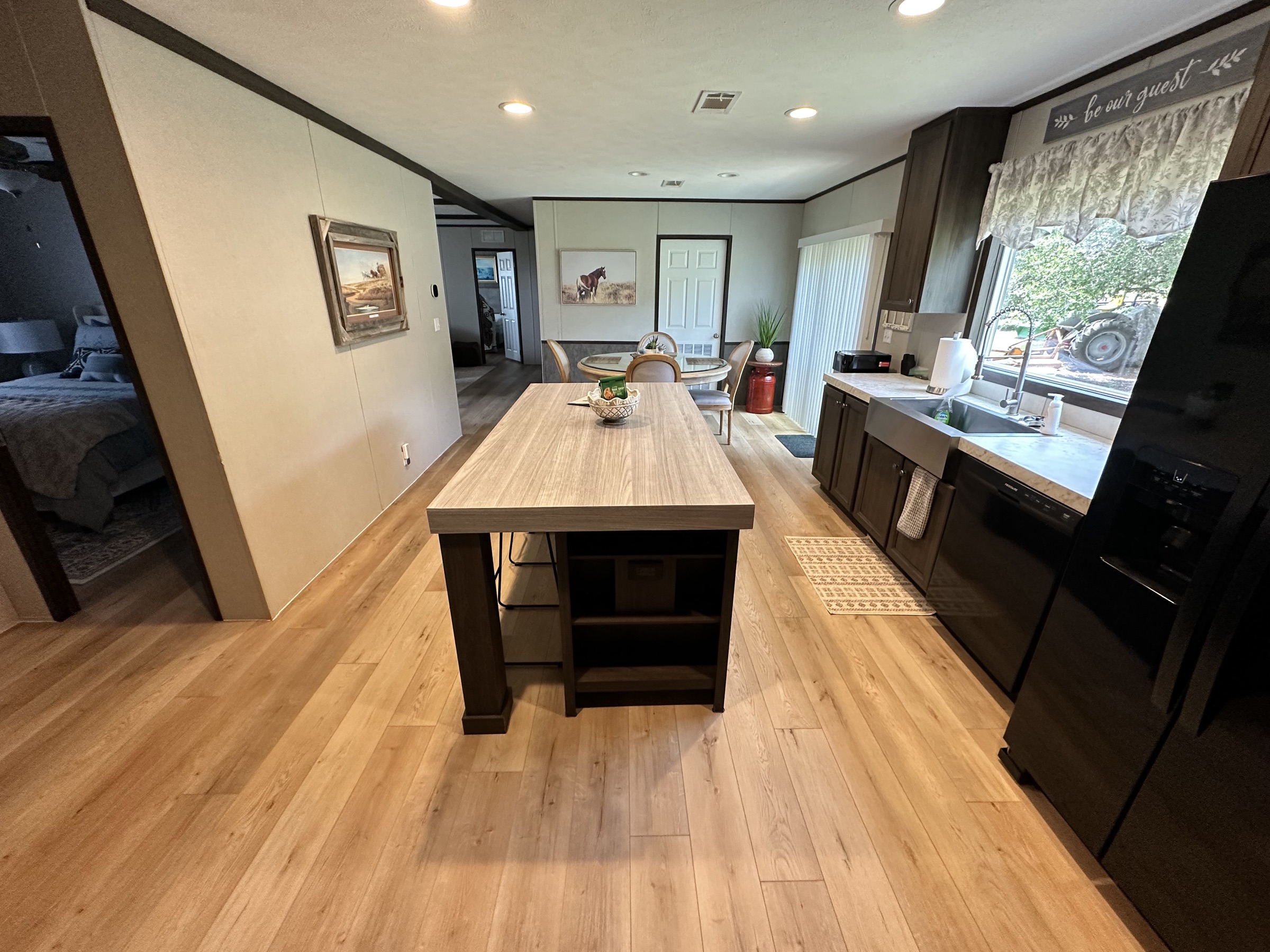 View down the kitchen island toward the living areas