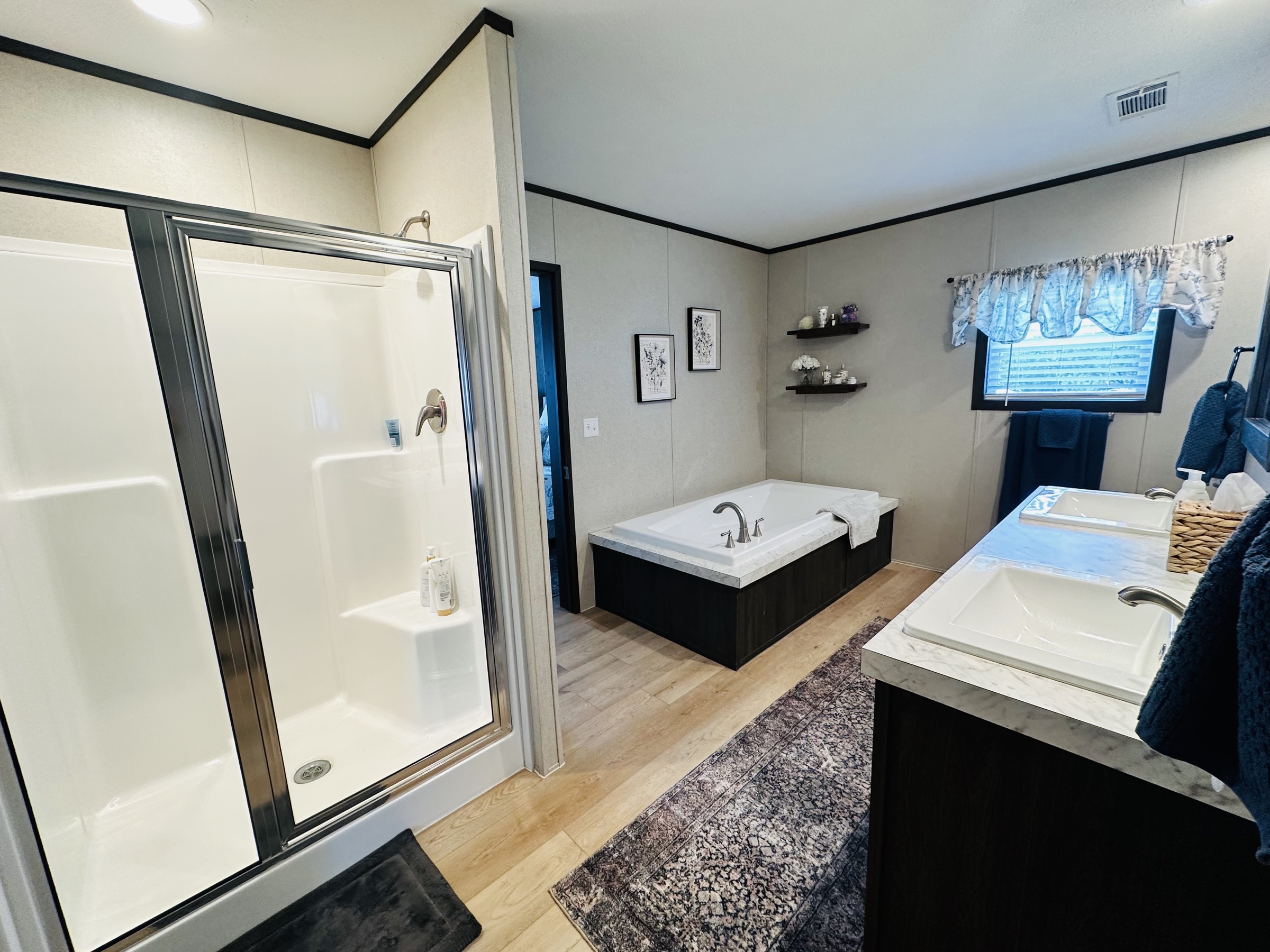 Primary bath with walk-in shower, garden tub, and double vanity