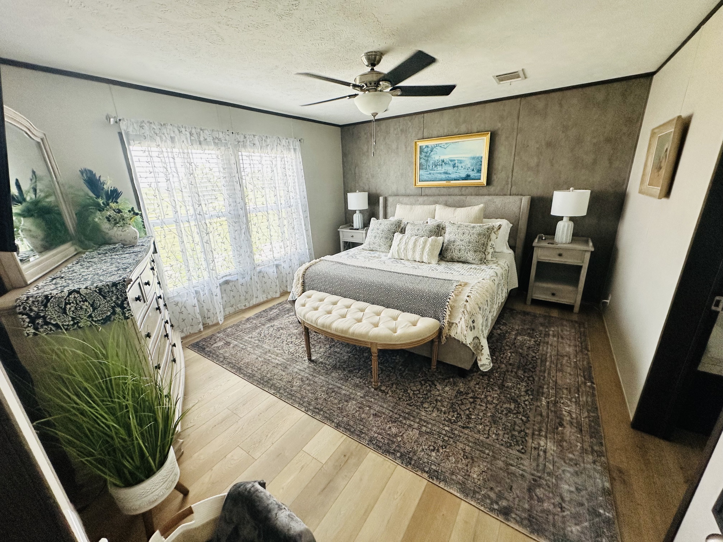 Primary bedroom with a king bed and sitting bench
